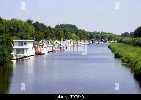 A row of Dutch houseboats in the Lange Wetering, city of Almere. Stock Photo