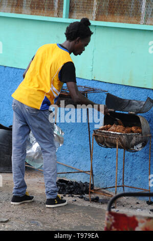 Port Antonio, Portland, Jamaica - 18th June 2017 : A Jamaican man is cooking the well known Jerk Chicken on a old rusty grill near Port Antonio in Jam Stock Photo