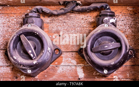 two dirty switches on the wall Stock Photo