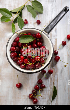 Fresh ripe cherry in white colander Stock Photo
