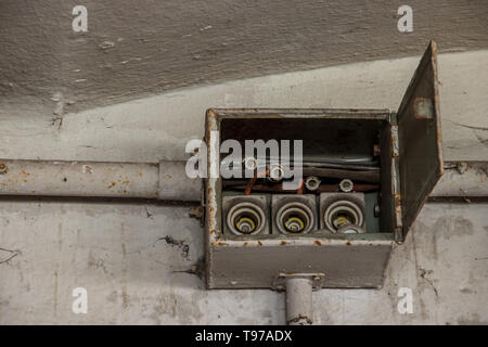 old electrical boxes on wall Stock Photo