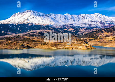 Lake of dam in gömbe District of Antalya with a cloudy sky and snowy mountain views Stock Photo