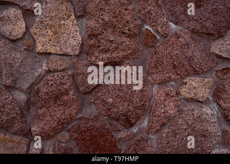 textured texture of a red, old stone wall. Wallpaper for background and design Stock Photo