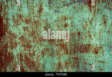 Rusty brown iron texture, green old fence with stains and peeling paint. Textured wallpaper for design. Stock Photo
