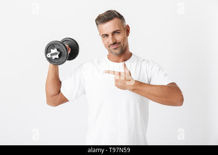 Image of european man 30s with bristle wearing casual t-shirt pumping biceps and lifting dumbbell isolated over white background Stock Photo