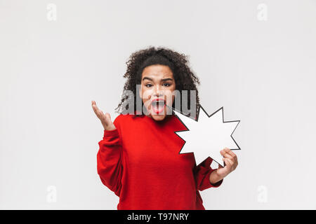 Angry screaming african woman in red sweater holding empty speech star and looking at the camera over grey background Stock Photo