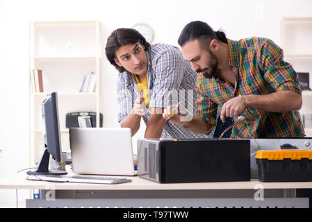 IT engineers working on hardware issue Stock Photo