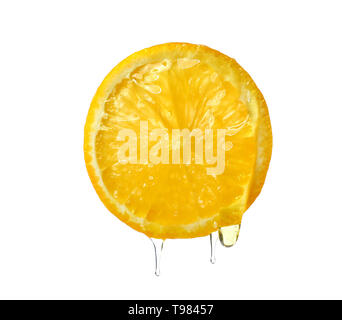 Essential oil dripping from orange slice on white background Stock Photo