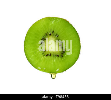 Essential oil dripping from kiwi slice on white background Stock Photo