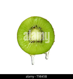 Essential oil dripping from kiwi slice on white background Stock Photo