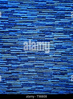 Picturesque, colorful and elegant facing of the wall of the fence, made of bonded thin plates of artificial granite, marble or other stone-forming mat Stock Photo