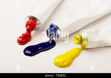 Tubes of three red, blue and yellow paint on a white background Stock Photo