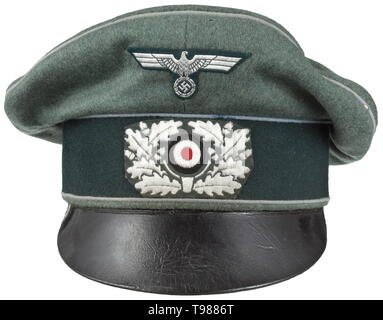 An old style visor cap for officers of motorised units maker Erel, Berlin Made of soft field-grey woollen cloth, dark green trim band, light blue piping (somewhat bleached out), yellow inner liner with silver stamped maker's marking, brown leather sweatband, visor of soft black leather. BeVo-weave insignia in officer quality. A used visor cap with signs of usage and age with minimal moth traces. historic, historical, army, armies, armed forces, military, militaria, object, objects, stills, clipping, clippings, cut out, cut-out, cut-outs, 20th century, Editorial-Use-Only Stock Photo