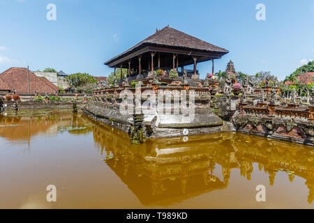 Bale Kembang (Floating pavilion) with carved stone statues at Taman Gili Kertha Gosa, remains of a royal palace.  Semarapura, Klungkung, Bali, Indones Stock Photo