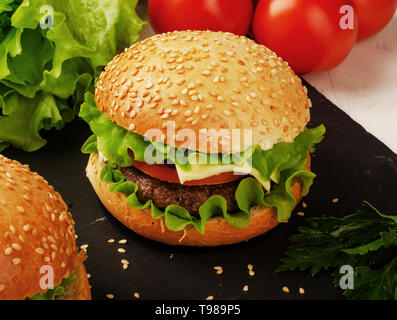 Close-up of home made burgers with salad and tomatoes Stock Photo