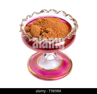 Coconut sugar in wintage glass bowl. Isolated on white background. Stock Photo