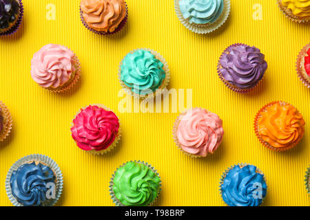 Different cupcakes on color background Stock Photo
