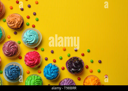Different cupcakes on color background Stock Photo