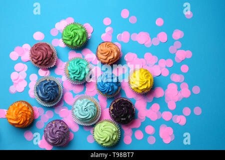 Different cupcakes on color background Stock Photo
