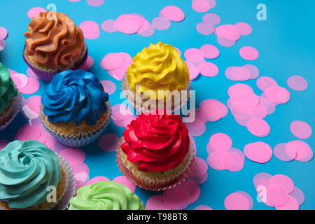 Different cupcakes on color background Stock Photo
