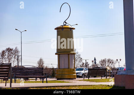 Leninsk Kuznetsk, Russia - 05.03.2019: Monument to the lantern of a miner of large sizes of yellow color with a hook on top of the square in memory of Stock Photo