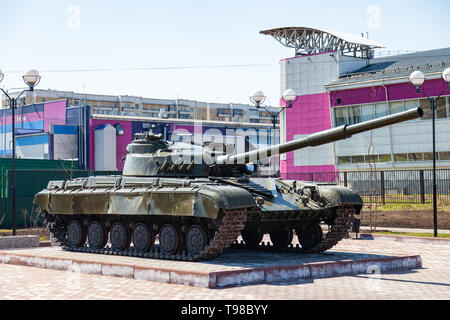 Military equipment on the monument in honor of the memory of the war, tanks and green guns on a clear summer day. Artillery guns and armored vehicles. Stock Photo