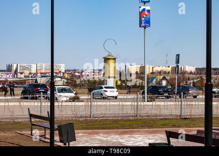 Leninsk Kuznetsk, Russia - 05.03.2019: Monument to the lantern of a miner of large sizes of yellow color with a hook on top of the square in memory of Stock Photo