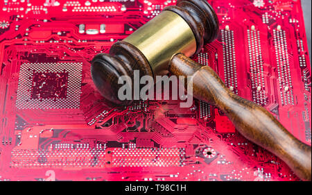 A big gavel over computer mainboard.Concept image law and judge for online internet Stock Photo