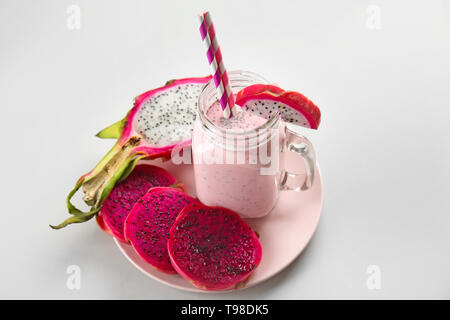 Mason jar of smoothie with dragon fruit on light background Stock Photo