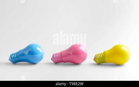 Painted light bulbs on white background Stock Photo
