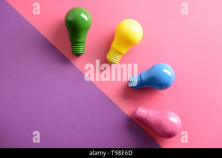 Painted light bulbs on color background Stock Photo
