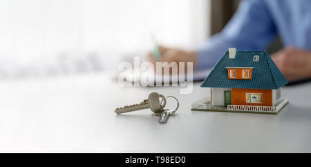 real estate business concept - new house scale model and keys on the tabe at realtor office. copy space Stock Photo