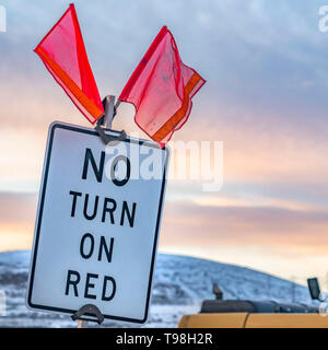 Square Close up of a No Turn On Red sign with red flags on top Stock Photo