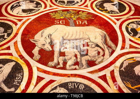 Siena Italy - October 25, 2018: Roman wolf with Romulus and Remus, founders of Rome marble mosaic floor in Siena Cathedral Stock Photo