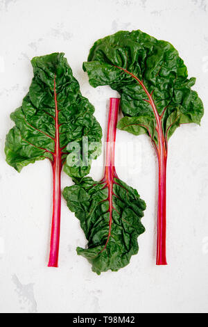 Swiss chard leaves on a rugged white background Stock Photo