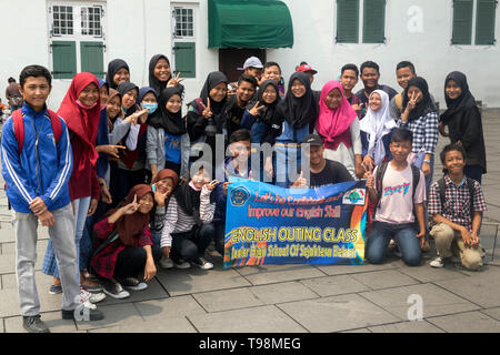 Group of Indonesian schoolchildren wanting to improve English skills in Jakarta Stock Photo