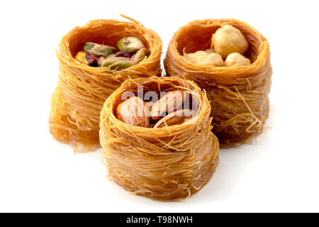 Mixed Bird nest baklava with almonds, nuts and pistachios on a white background Stock Photo