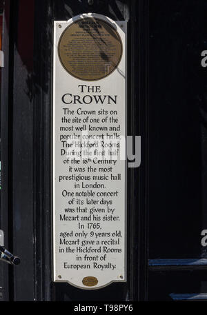 The Crown public house, Brewer Street, Soho, London, England, UK; plaque giving account of the history of the Hickford Rooms. Stock Photo
