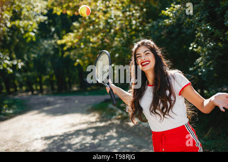 Girl on the tennis court. Stylish lady in a sports clothes Stock