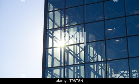Summer sun shines through a modern glass building Stock Photo