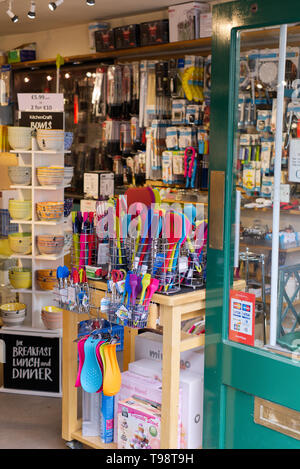 Colourful silicone cooking utensils on display at a shop in Wells, Somerset, UK Stock Photo
