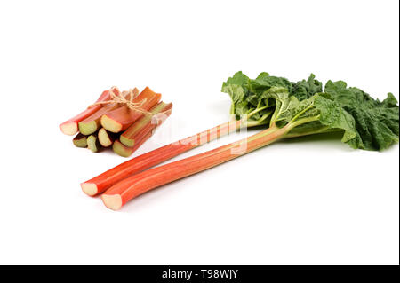 Rhubarb isolated. Red stalks , bunch of cut rhubarb  on white. Fresh and juicy ready to be cooked.Image with copy space.Selective focus. Stock Photo