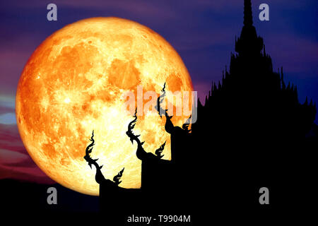 super blood moon back over silhouette art on roof of Buddhist temple and sunset sky, Elements of this image furnished by NASA Stock Photo