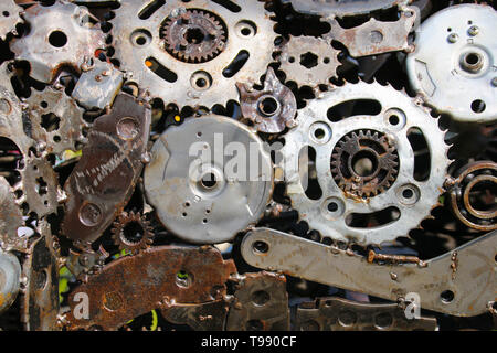 An industrial abstract textured background of recycled scrap metal car parts welded together Stock Photo