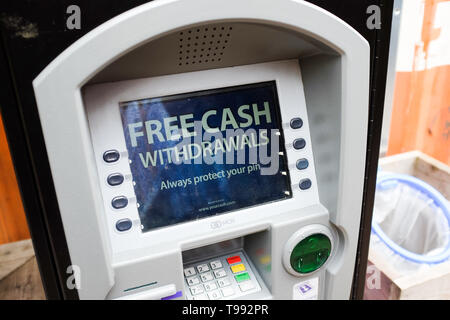 A cash machine showing "free cash withdrawals". Stock Photo