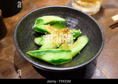 Chopped cucumber with a sprinkling of shichimi (seven spice mix) and sesame seeds. Stock Photo