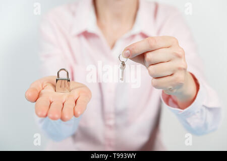 Padlock on the hand metal lock isolated on white background - Security Concept Stock Photo