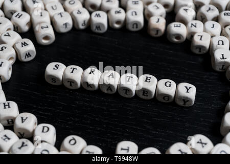 Word STRATEGY on wooden cubes on a black wooden table with copy space Stock Photo
