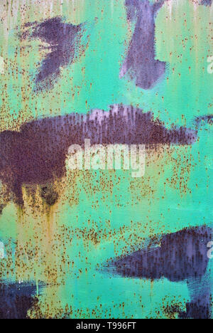 Old rusty surface painted with turquoise shabby paint, vertical grunge background texture Stock Photo