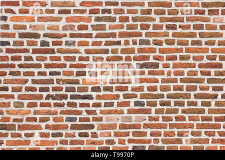 Full-frame red old brick wall horizontal image with old colorful stones Stock Photo